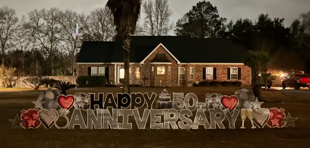 Happy Anniversary yard sign at night